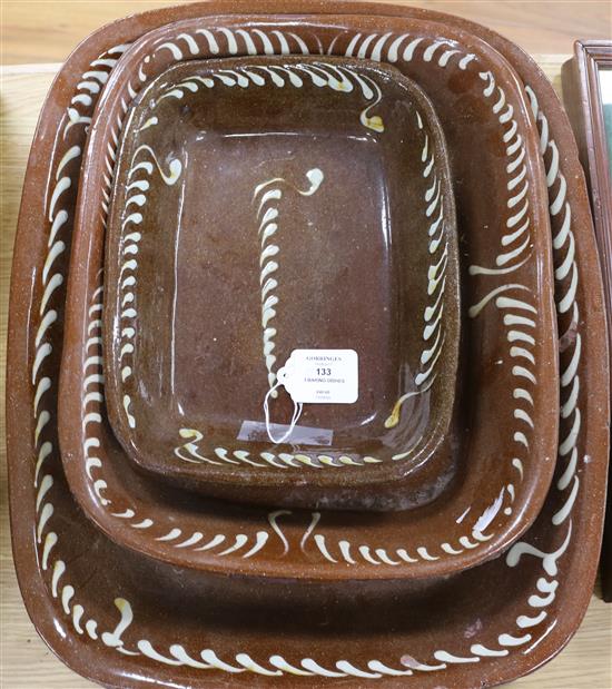 Three 19th century slip-decorated baking dishes